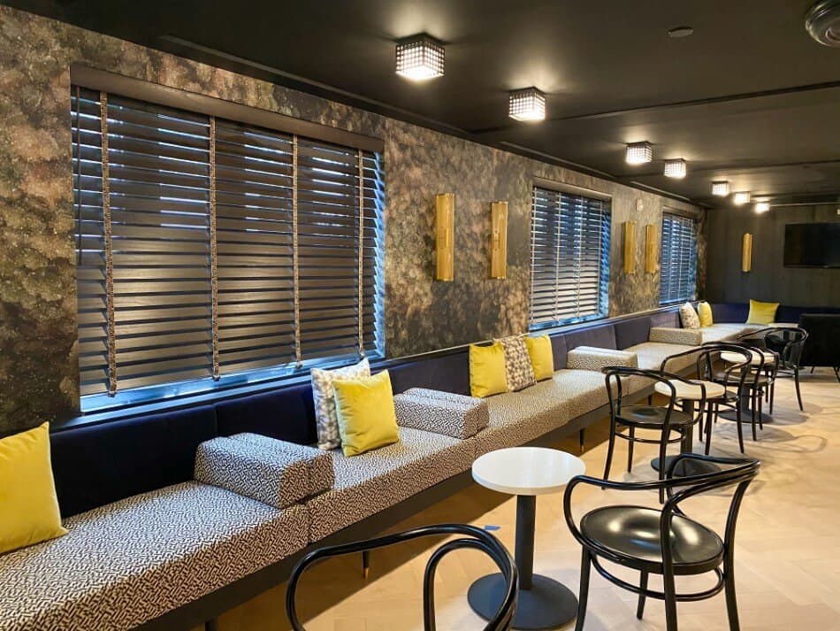 Commercial hospitality boutique hotel lounge with custom wood window blinds and banquette seating in Calgary, Toronto, and Vancouver